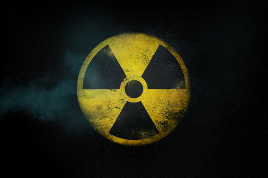 Nuclear energy radioactive round yellow symbol on asphalt texture