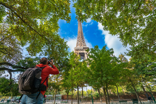 Eiffel Tower being photographed by tourist in Paris. France