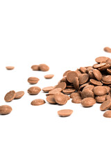 Close up of milk chocolate chips. Scattered chocolate callets isolated on white. Texture of chocolate. Vertical photo