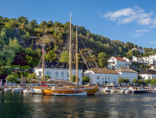 Tall ships in the old harbor of the historical seaside resort town of Risør on the southern coast...