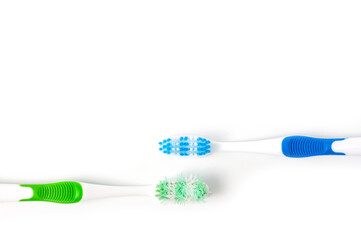 Used and new toothbrushes shot side by side for comparison.