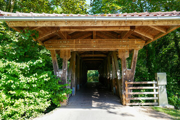 Fototapeta na wymiar Fulda Bridge in the Fulda Valley. Pedestrian and cyclist bridge made of a wooden structure. 