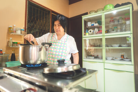 Authentic Portrait Asian Elderly Woman Cooking Local Traditional Thai Style Food.