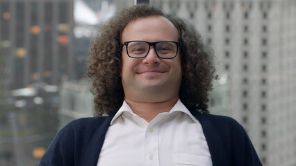 Nerdy looking manager enjoying promotion, sitting at his new working desk