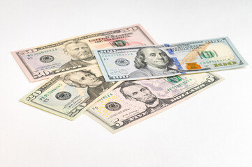 5, 20, 50, 100 dollars banknotes at different angles. Close up of dollars on white background.