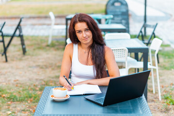 Attractive sensual successful young caucasian woman working remotely at laptop device in...