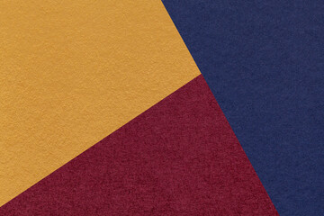 Fototapeta premium Texture of craft navy blue, wine and yellow shade color paper background, macro. Vintage abstract cardboard