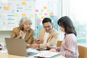 Group of  Asian business working together in a modern office.Talk to colleagues about new startup projects, business people discussing and brainstorming in the meeting room. .