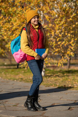 teen girl smile back to school in autumn. full length
