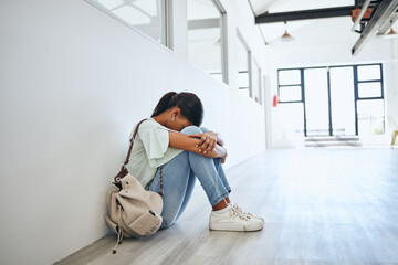 Sad, depression and mental health issue of a woman university student on a floor. Fear, anxiety and...