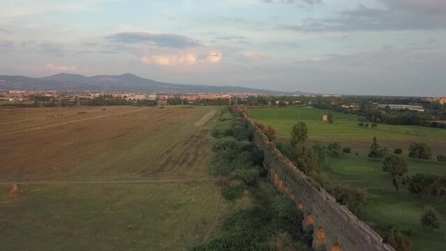 Aerial flyover of ancient Roman Claudio Aqueduct ruin in Rome, Italy