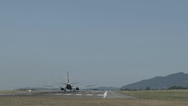 Passenger plane taking off on the airport runway, hot air distortion effects visible