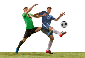 Soccer football players tackling for the ball on grass flooring over white background. Concept of sport, action, competition, football match