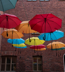 Fototapeta na wymiar colorful umbrellas on the background of a brick wall