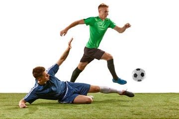 Fototapeta na wymiar Soccer football players tackling for the ball on grass flooring over white background. Concept of sport, action, competition, football match