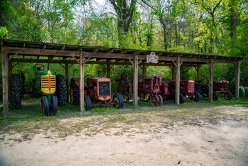 Fototapeta na wymiar old broken tractors showed in an old plantation property in South Carolina
