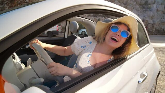 concept of summer holidays and auto travel. Happy young woman in a hat in a cabriolet