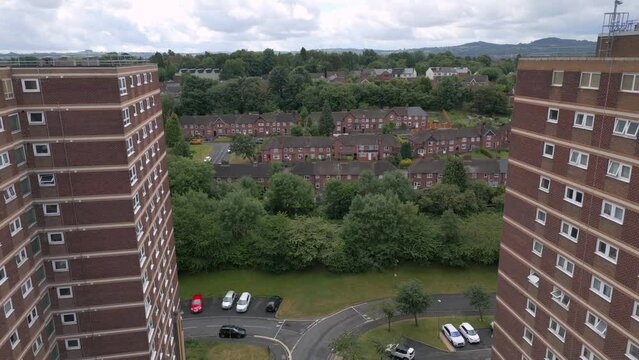 Aerial reveal of an English residential area with tower blocks of flats