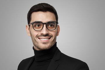 Man in black with glasses looking aside as if staying in thoughts and ideas, seeking for solution