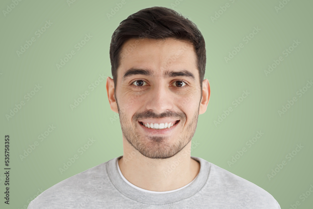 Sticker Close-up portrait of smiling handsome unshaven man isolated on green