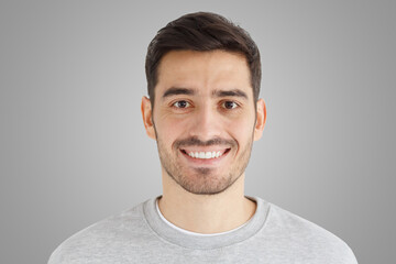 Close-up daylight portrait of handsome man with smile isolated on gray background