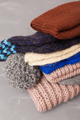 knitted brown baby romper and nipple, pink hat and toy on warm knitted blanket. autumn set of baby clothes. top view and flat lay