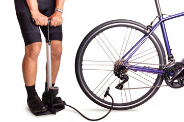 Cyclist using floor pump inflate air into a bicycle tire - obrazy, fototapety, plakaty