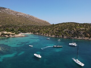 Obraz premium Aerial view of Cala Moresca and Figarolo Island in Golfo Aranci, north Sardinia. Birds eye from above of yacht, boats, crystalline and turquoise water. Tavolara Island in the background, Sardegna.
