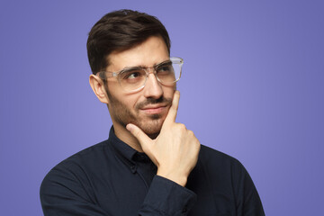 Thoughtful pensive businessman isolated on purple