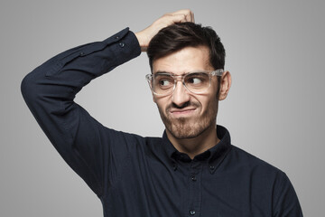 Fototapeta premium Thoughtful business man thinking, scratching his head trying to find solution