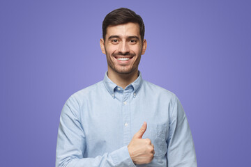 Handsome male showing thumb up approving and advising service or product