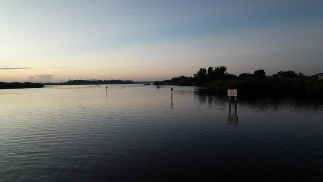 Beautiful shot of a boat sailing in Braden River at Sunrise, Florida