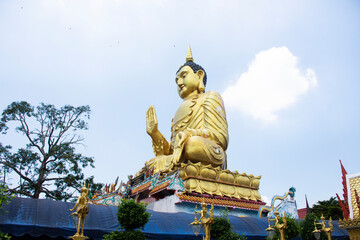 Big buddha statue of Wat Maniwong for thai people travel visit and respect praying blessing holy worship mystical in Mani Wong temple at Nakhonnayok city on September 6, 2022 in Nakhon Nayok Thailand