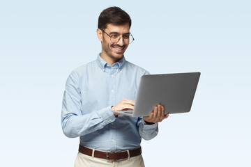 Portrait of businessman holding laptop and watching media with happy smile, sharing web content