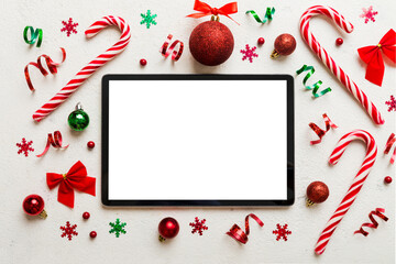 Top view of empty tablet on Christmas background made of new year decorand festive decorations. New year holiday concept. Mockup