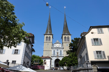 Fototapeta na wymiar LUCERNE, SWITZERLAND, JUNE 21, 2022 - View of the Court Church of Saint Leodegar (Hofkirche Sankt Leodegar) in Lucerne, Switzerland