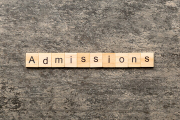 admissions word written on wood block. admissions text on table, concept