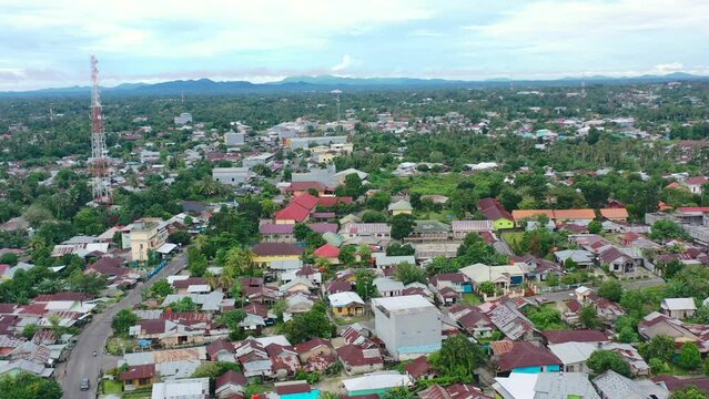 aerial of a local town in Belitung Indonesia on cloudy day with traditional houses and buildings