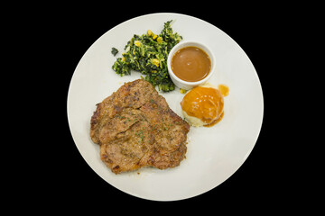 Top view of pork Steak with Black Pepper on a white plate, focus selective