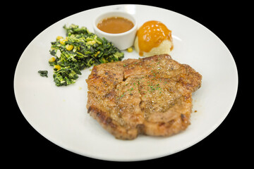Top view of pork Steak with Black Pepper on a white plate, focus selective