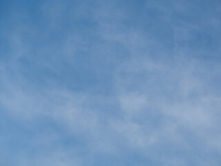 Blue sky with a light white haze of clouds for decorative background and design. The gradient heaven
