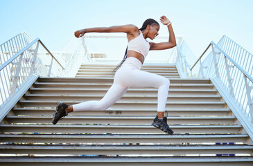 Energy, running and black woman runner on steps for outdoor fitness training, wellness exercise or sports speed challenge. Strong, healthy power of an african athlete with strength workout motivation
