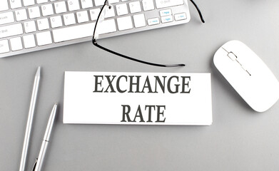 EXCHANGE RATE text on paper with keyboard on grey background