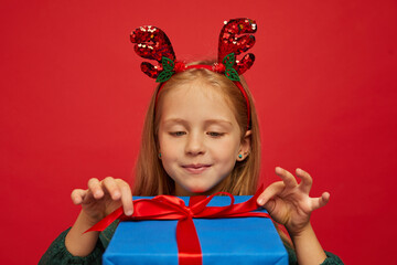 Smiling funny child (kid, girl) in Reindeer Hairband