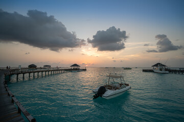 A jetty at sunset in the Maldives
