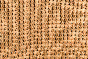 Brown wool knitted textured background close up. Handmade knitted fabric brown wool background texture