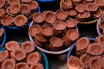 diya or clay lamp at market during Diwali festival in India.