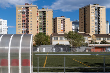 Soccer field and blocks of buildings in the background