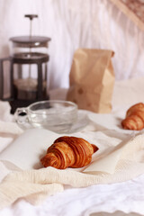 Vertical shot of a simple french breakfast of croissants and coffee prepared in a french coffee press