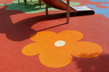 red, orange and yellow padded granular soft rubber safety and sports floor. play surface. kids...